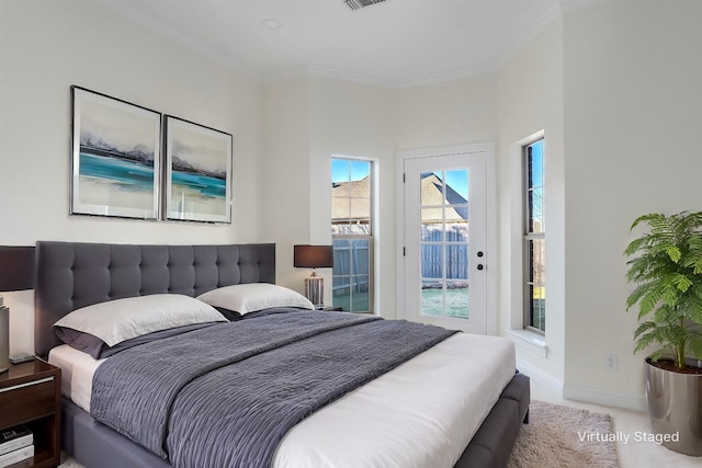 bedroom with access to exterior, ornamental molding, and carpet flooring