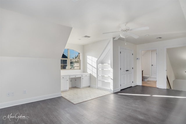 additional living space featuring ceiling fan, wood-type flooring, and built in desk