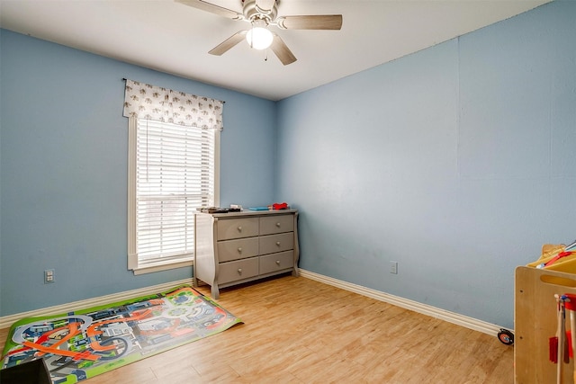 rec room with light wood-type flooring and ceiling fan