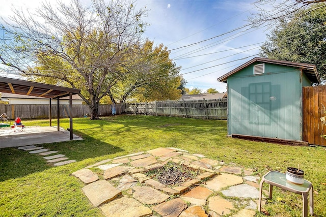 view of yard with a patio area and a storage shed