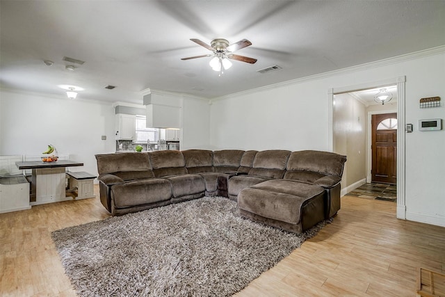 living room with ceiling fan, light hardwood / wood-style flooring, and crown molding