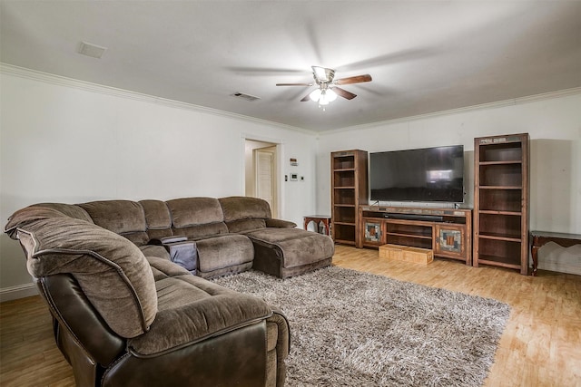 living room featuring ceiling fan, wood-type flooring, and ornamental molding