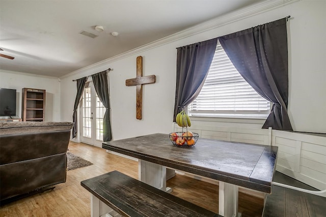 dining room with ceiling fan, french doors, light hardwood / wood-style floors, and ornamental molding