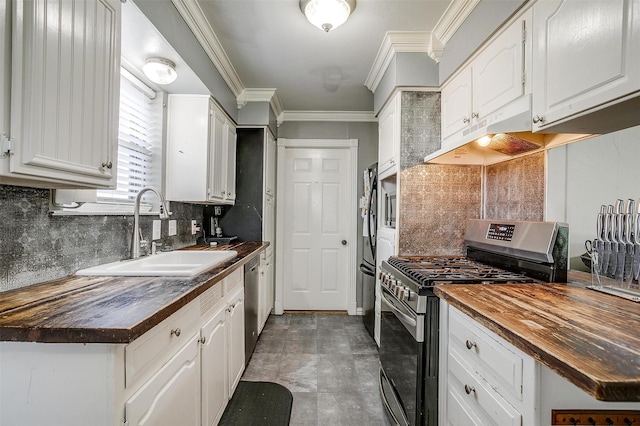 kitchen featuring white cabinets, sink, butcher block counters, and stainless steel appliances