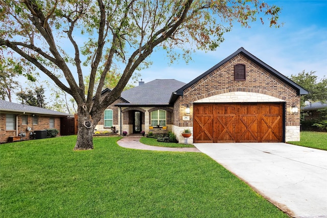 view of front of house with a front lawn, a garage, and central AC unit