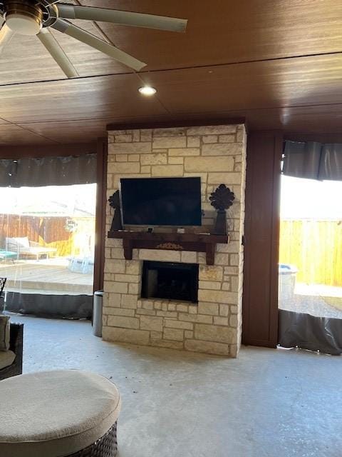 living room with wooden ceiling, a fireplace, and concrete floors