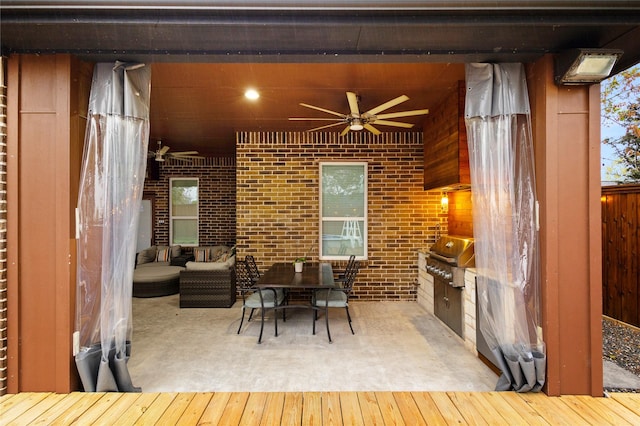 dining area featuring ceiling fan, concrete floors, and brick wall