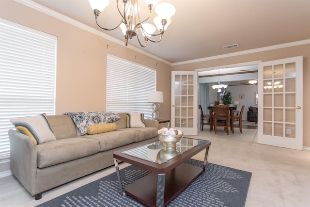 living room featuring an inviting chandelier, crown molding, and french doors