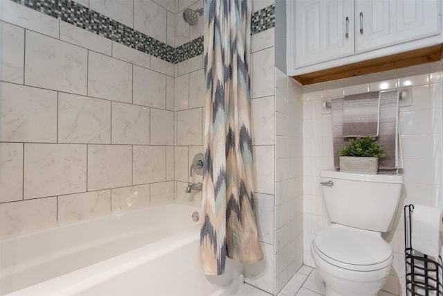 bathroom featuring tile patterned flooring, shower / bath combo, toilet, and tile walls