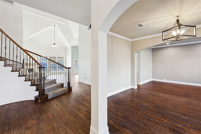 entrance foyer featuring arched walkways, visible vents, baseboards, and stairs