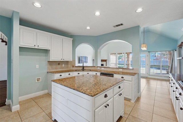 kitchen featuring visible vents, dishwashing machine, a center island, a sink, and light tile patterned flooring