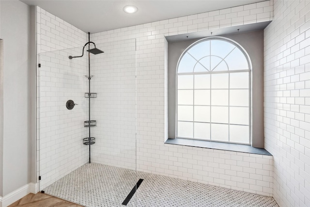 bathroom featuring a tile shower and recessed lighting