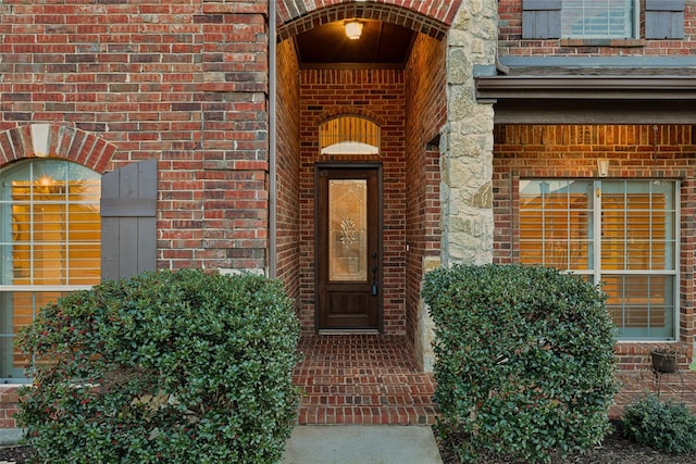 property entrance featuring brick siding