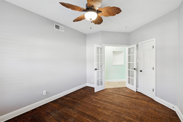 empty room with french doors, ceiling fan, and wood-type flooring