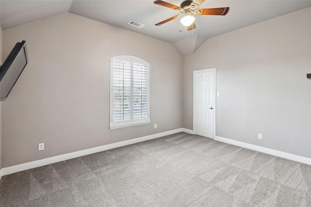 unfurnished room featuring lofted ceiling, visible vents, and carpet flooring