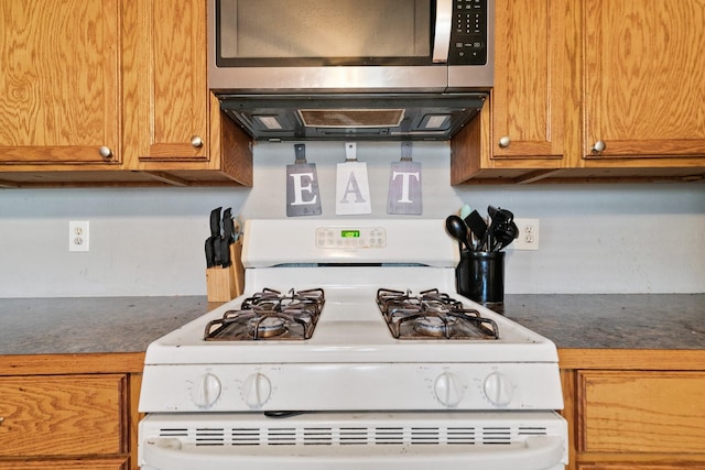 kitchen featuring white range with gas stovetop