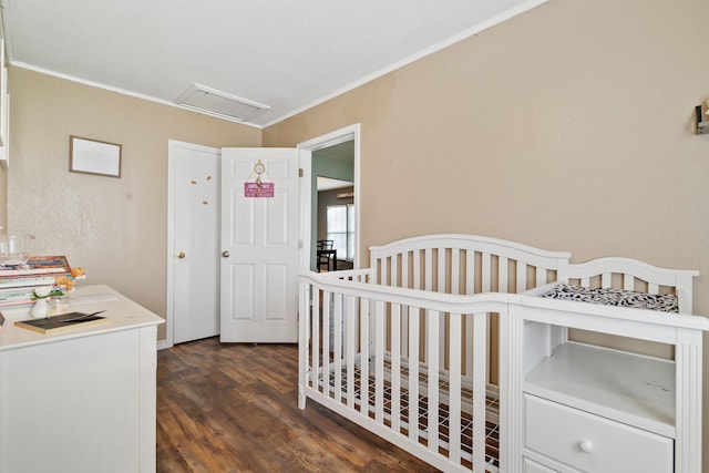 bedroom with crown molding and dark hardwood / wood-style flooring