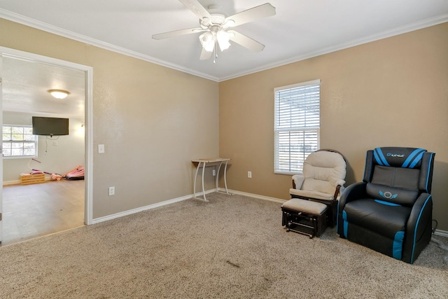 sitting room featuring ornamental molding, carpet floors, and ceiling fan