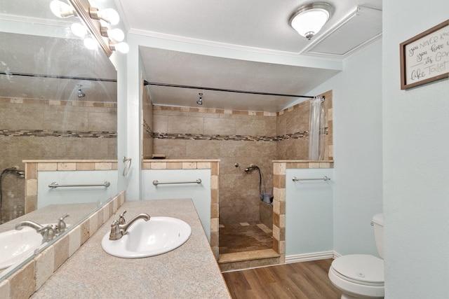 bathroom with toilet, crown molding, wood-type flooring, vanity, and a shower with shower curtain