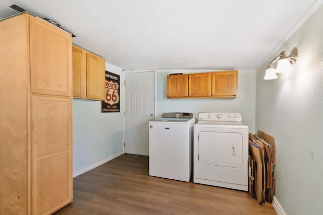 washroom with cabinets, wood-type flooring, and separate washer and dryer