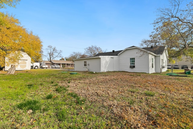 exterior space with a lawn and a shed