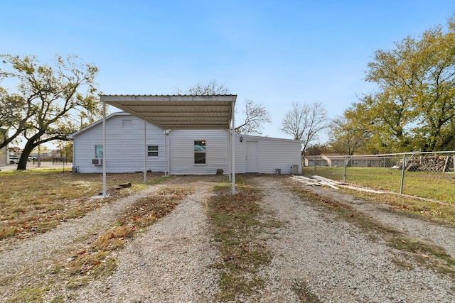 view of side of home with a carport