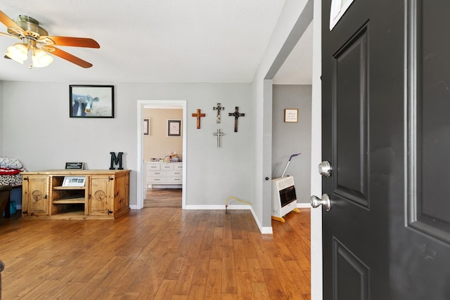 entrance foyer with ceiling fan, light hardwood / wood-style floors, and heating unit