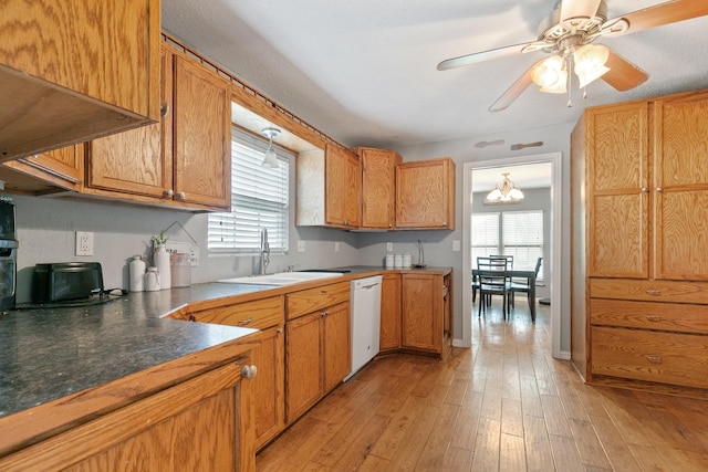 kitchen with sink, ventilation hood, light wood-type flooring, dishwasher, and ceiling fan with notable chandelier