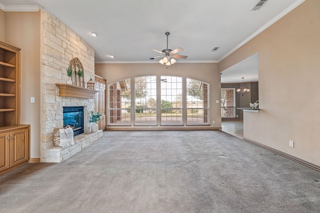 unfurnished living room featuring crown molding, carpet flooring, a fireplace, and ceiling fan with notable chandelier