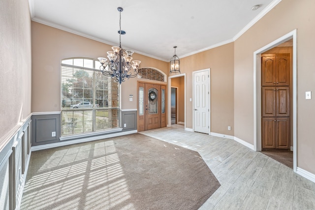 unfurnished dining area with an inviting chandelier, crown molding, and wood-type flooring