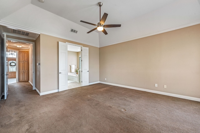 empty room featuring vaulted ceiling, ornamental molding, ceiling fan, and dark colored carpet