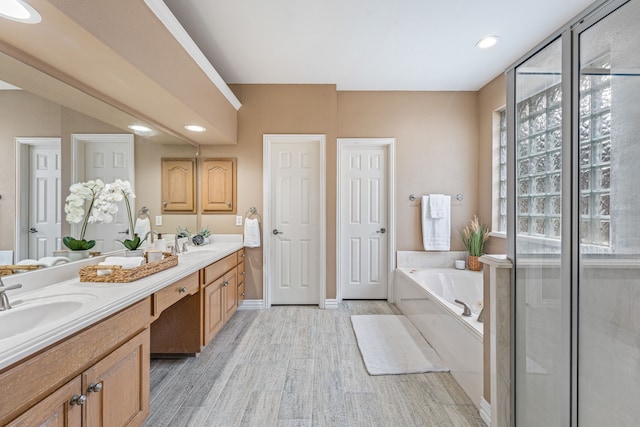 bathroom with vanity, hardwood / wood-style floors, and separate shower and tub