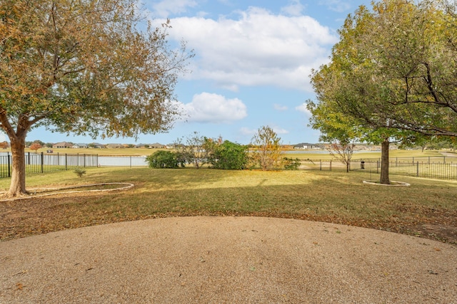 view of yard with a rural view and a water view