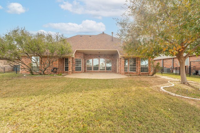 rear view of property with a patio and a yard