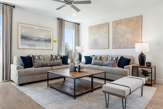 living room with ceiling fan and light hardwood / wood-style floors