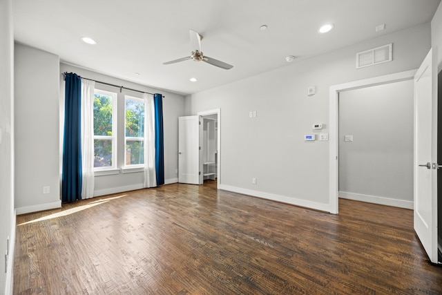 unfurnished bedroom featuring ceiling fan and dark wood-type flooring