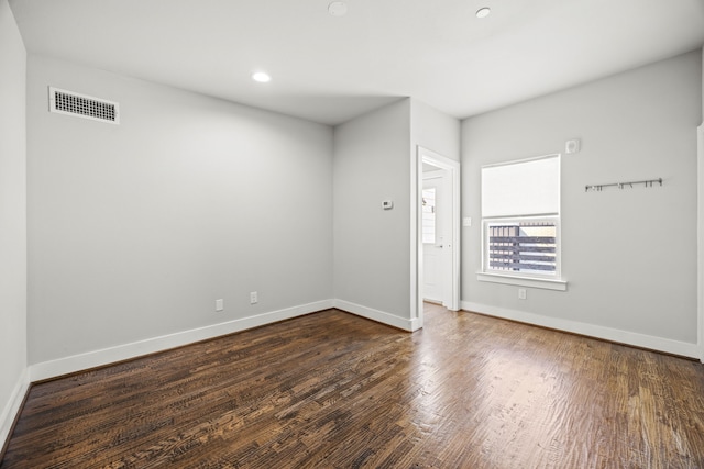 unfurnished room with dark hardwood / wood-style floors