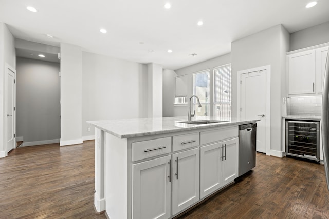 kitchen featuring sink, wine cooler, stainless steel dishwasher, a center island with sink, and white cabinets