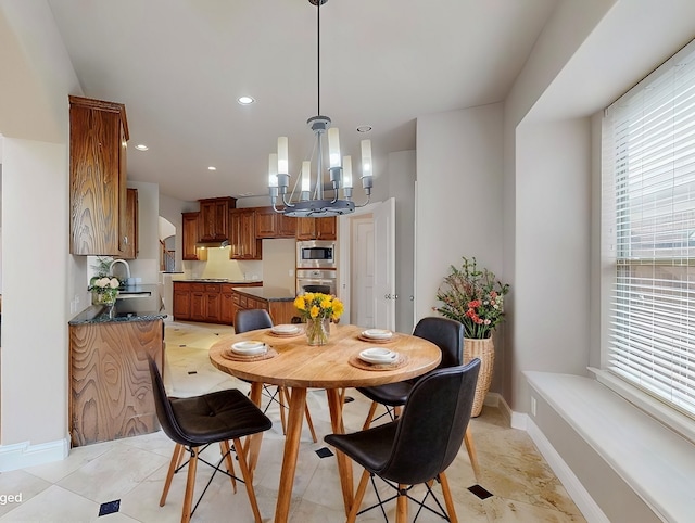 dining room featuring a chandelier, recessed lighting, and baseboards