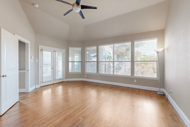 spare room featuring light wood-style floors, a wealth of natural light, and baseboards