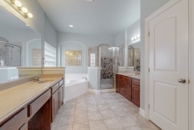 bathroom with tile patterned flooring, vanity, and plus walk in shower