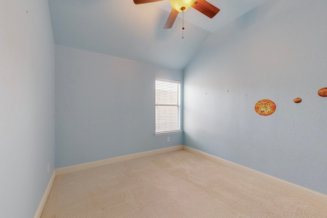 empty room with ceiling fan, carpet floors, and vaulted ceiling