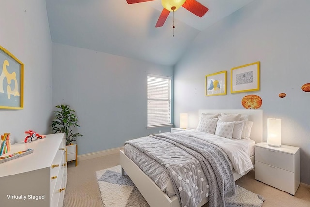 bedroom with a ceiling fan, light carpet, vaulted ceiling, and baseboards