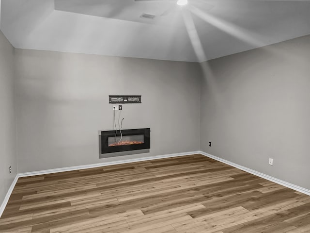 unfurnished living room with lofted ceiling and wood-type flooring