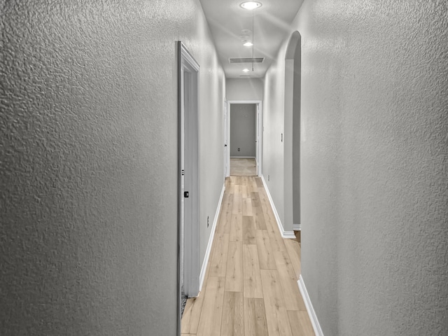 corridor featuring light hardwood / wood-style floors