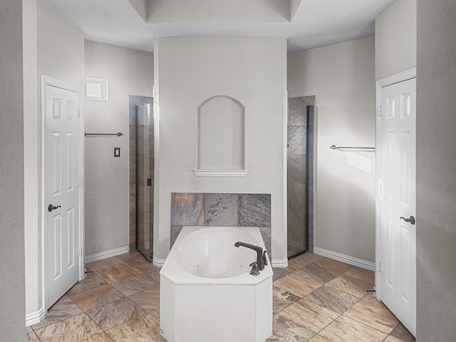 bathroom featuring separate shower and tub