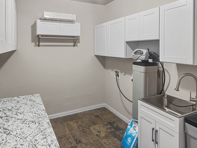 washroom featuring cabinets, washer hookup, hookup for a gas dryer, and sink