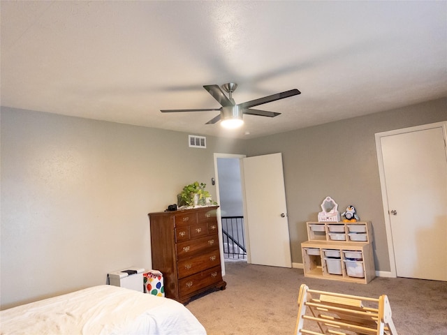 bedroom featuring light carpet and ceiling fan