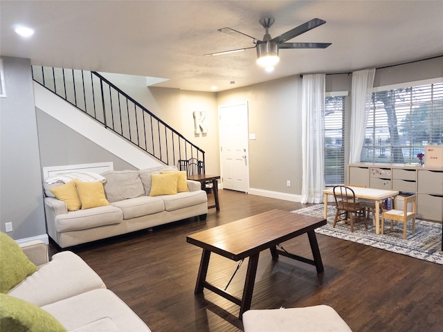 living room with ceiling fan and dark hardwood / wood-style flooring