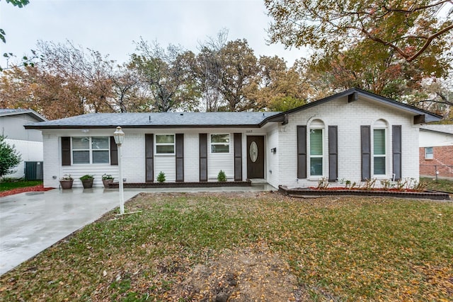 ranch-style home with a front yard and central AC